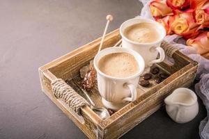 Cup of coffee in vintage wooden tray photo