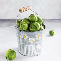 Fresh Brussels sprouts in metal bucket photo