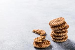 Glass cup of coffee with syrupwaffles cookies photo