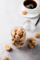 Amaretti cookies with white cup of coffee photo