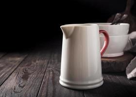 Ceramic white jug with red handle