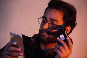 man using mobile and have gaming wireless joystick photo