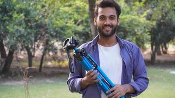 Young blogger with tripod -Indian Blogger images photo