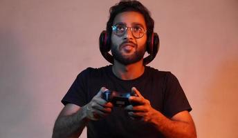 man playing game using gaming wireless joystick photo