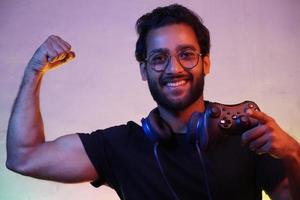 exited man using playing video game using gaming wireless joystick- gaming concept photo