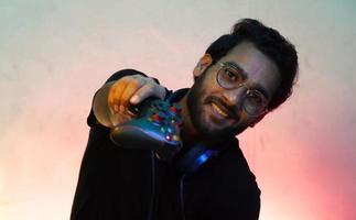 man giving gamepad which is wireless joystick- gaming concept photo