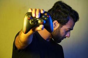 man showing wireless joystick- gaming concept photo