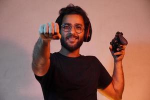 Boy playing video game with Joystick and beliving he will win the game photo