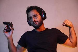 Boy playing video game with Joystick and beliving he will win the game photo