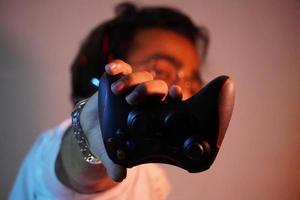 man using mobile and have gaming wireless joystick photo