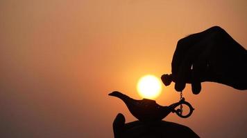 aladdin magic lamp in sky with sun photo