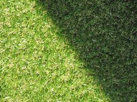Green artificial synthetic grass meadow background photo