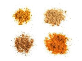 many spices including Ginger Curry Turmeric and Chili Pepper over white photo