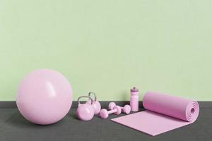 pink yoga equipment in room with green wall photo