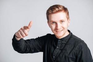 Portrait of a young man in a black shirt on a white background. Copy, empty space for text photo