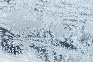 Ice patterns on frozen glass. Abstract ice pattern on winter glass as a background image