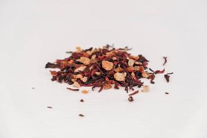 Dry fruit tea scattered on a white table background. Copy, empty space for text photo