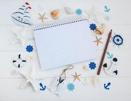 Shells and notepad on wooden table photo