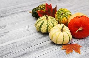 Pumpkins with autumn leaves photo