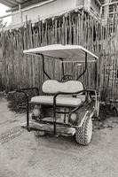 Golf cart buggy cars carts muddy street village Holbox Mexico. photo