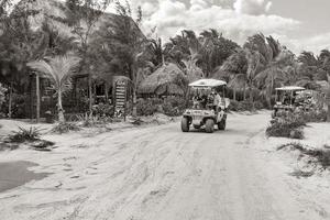 Holbox Mexico 22. December 2021 Golf cart taxi cars carts muddy street beach Holbox Mexico. photo