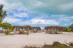 Beautiful Holbox island beach sandbank panorama palapa sun loungers Mexico. photo