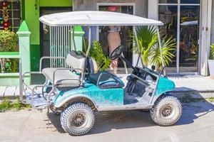 Golf cart buggy cars carts muddy street village Holbox Mexico. photo