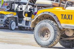 Holbox Mexico 21. December 2021 Golf cart taxi cars carts wheel street beach Holbox Mexico. photo