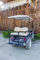 Golf cart buggy cars carts muddy street village Holbox Mexico. photo