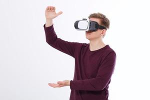 Excited young man in a VR headset, glasses . Virtual reality isolated on white background. Copy space and mock up photo