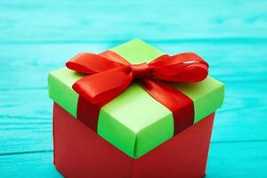 Gift box on blue wooden background. Selective focus photo