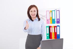 Smiling Businesswoman and big thumb up isolated on white background at office. Business success concept. Woman at work photo