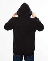 man in a black sweatshirt with a hood on his head is isolated on a white background - back view, top view photo