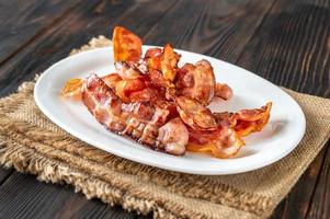 Fried bacon on the serving plate photo