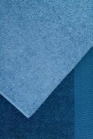 bath towel one on the other, blue. textured fabric background photo