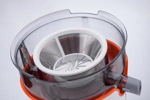 top of electric juicer with blades on light background. kitchen appliances photo