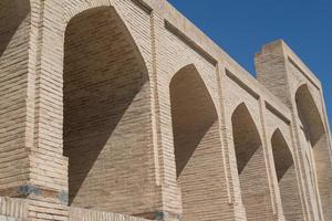 The old building, the wall with arches. Ancient buildings of medieval Asia. Bukhara, Uzbekistan photo