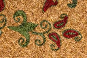 Background from the tissue with oriental ornaments and multi colored pattern, textile photo