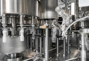 filling milk in to plastic bottles at the factory. equipment at the dairy plant photo