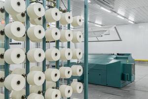 textile yarn on the warping machine. machinery and equipment in a textile factory photo