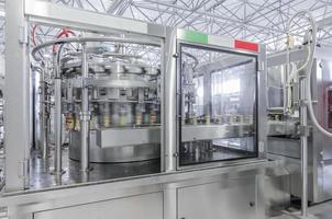 conveyor belt in motion at production and bottling of drinks in tin cans. production and bottling of drinks in tin cans photo