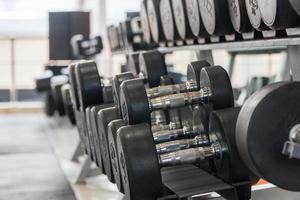 row of dumbbells in a modern gym photo