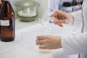 woman testing samples of dairy products in the laboratory. test laboratory of a milk factory photo