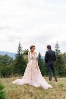 The bride and groom celebrate their wedding in the mountains. Wedding photography. Wedding ceremony for two. photo