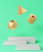 White base arranged in three pieces and three floating gold geometric objects on turquoise background, minimalist background for branding and presentation. 3d rendering photo