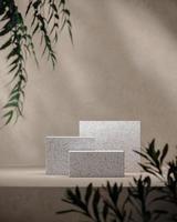 Three white terrazzo on mockup beige scene, blur plants foreground. background for product presentation or ads. 3d rendering photo