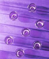 glass of wine is placed on a violet surface. 3d rendering photo