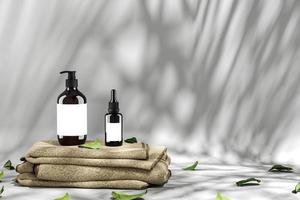 Minimalist background for cosmetic and spa presentation, Two cosmetic bottle on brown fabric, leaves scattered around. 3d rendering photo