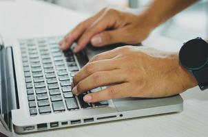 Male hands using computer for information or social media and communication business photo