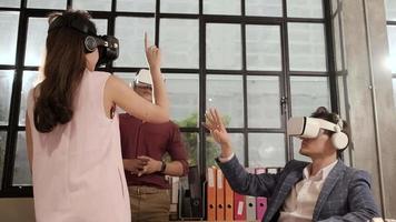 Multiracial workers use VR headset simulator equipment to visualization 3D cyberspace, view and interactive touch, futuristic digital workspace at the office, gadget device, exciting experience. video